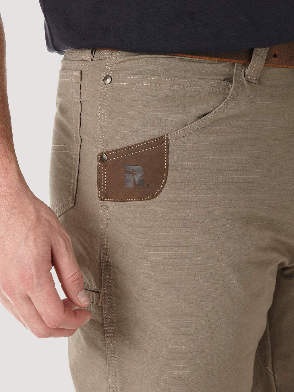 Close-up of the leather tape-measure reinforcement at the front pocket of Dark Khaki RIGGS Technician pants.
