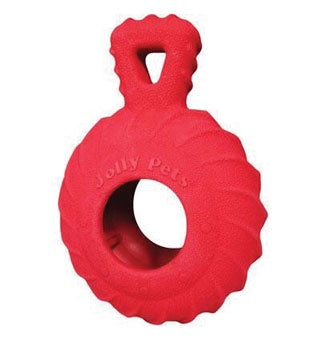 A red, circular rubber dog toy with a textured treaded surface and an integrated handle.