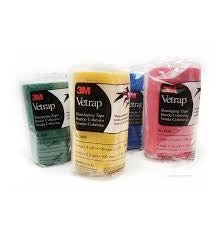 Four rolls of 3M Vetrap cohesive bandage wrap in green, yellow, blue, and pink.