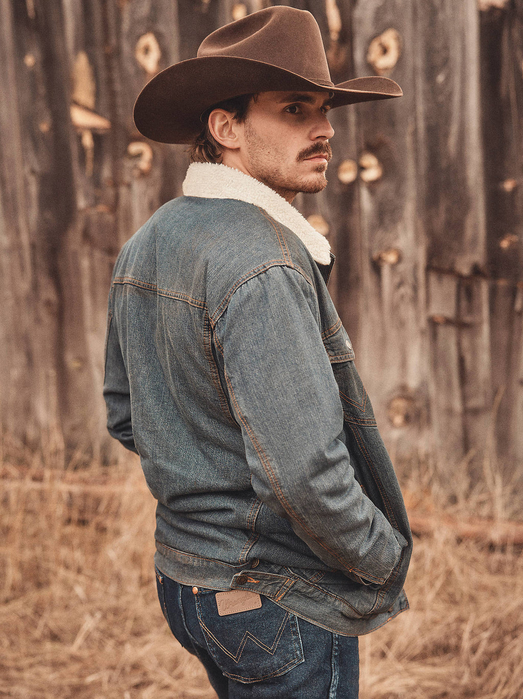 Wrangler Men's Western Sherpa-Lined Denim Trucker Jacket - Rustic, outdoor back view