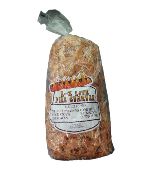 A clear plastic bag filled with E-Z Lite fire starter wood shavings.