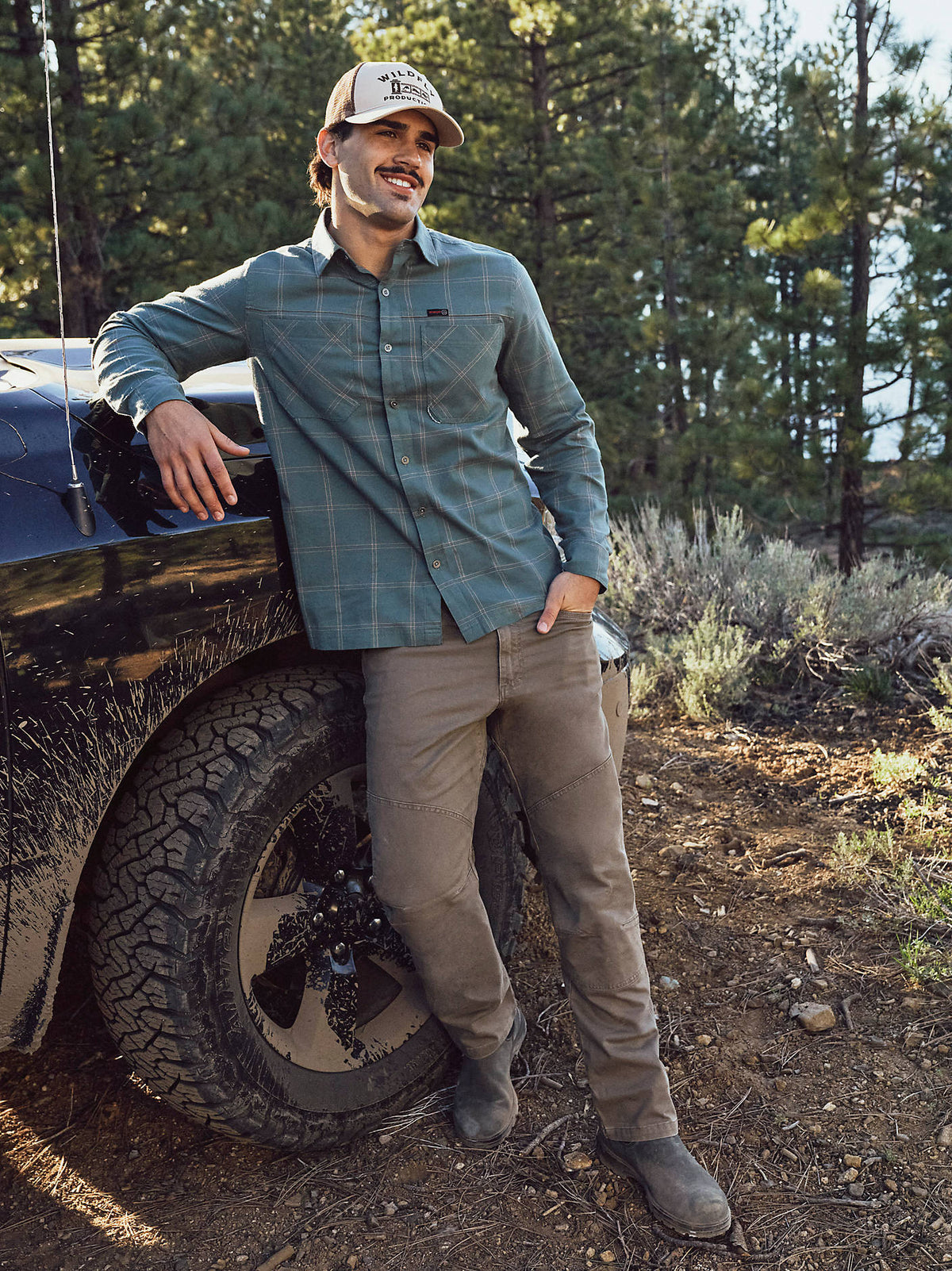 Wrangler Men's ATG Jackson Utility Pants in Morel, outdoor view beside a truck