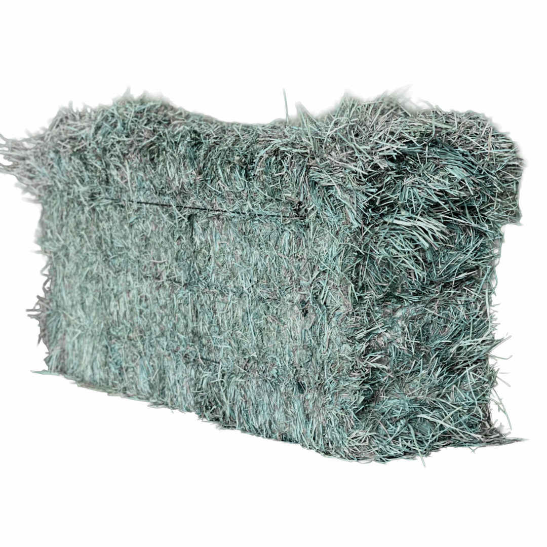 A rectangular bale of dried orchard grass hay with a green, textured appearance.