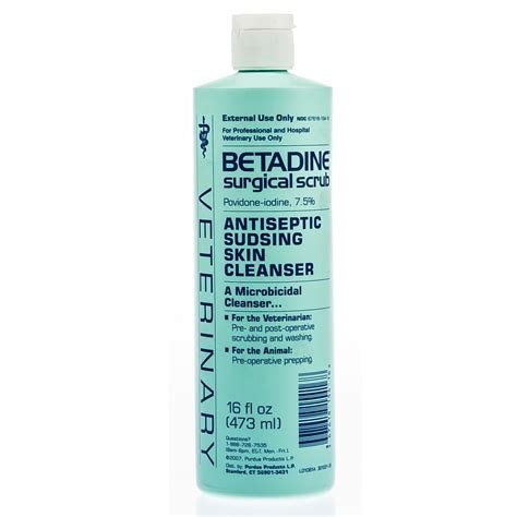 A 16 fluid ounce bottle of Betadine Surgical Scrub, a povidone-iodine antiseptic skin cleanser.