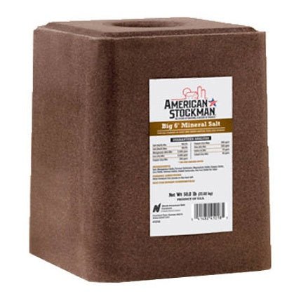 A 50-pound brown mineral salt block for livestock with a product label on the front.
