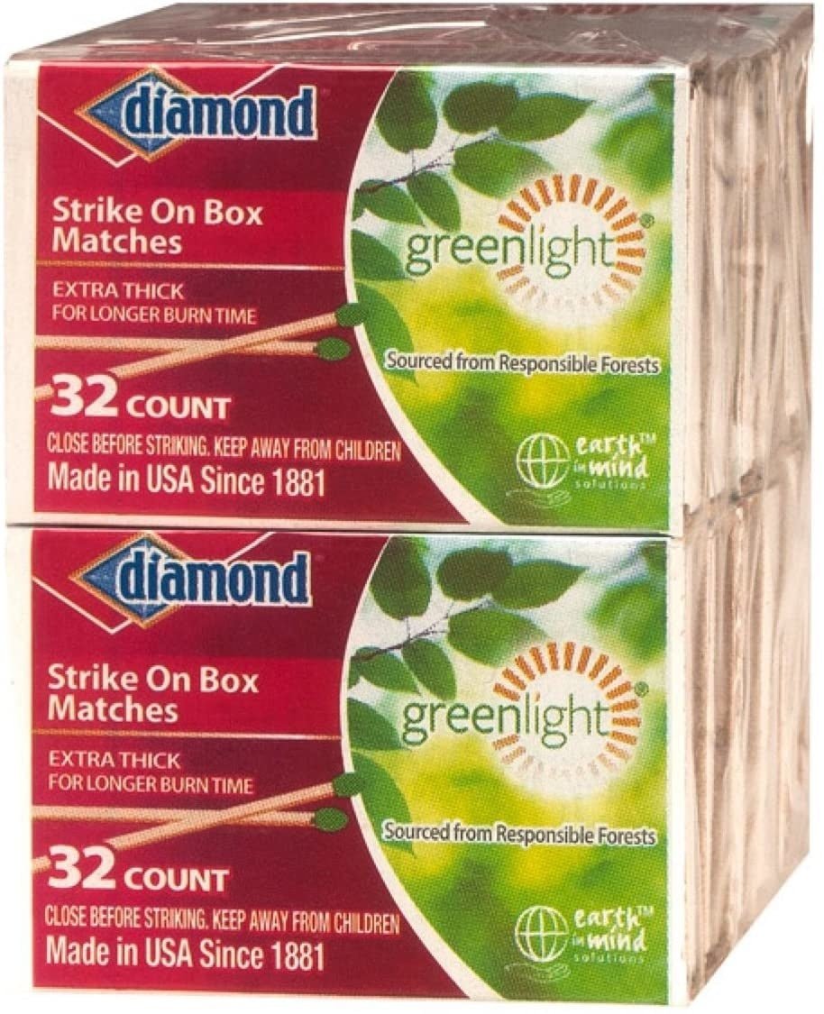 Two stacked boxes of Diamond strike-on-box wooden matches with green leaf branding.