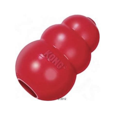 A red, three-tiered rubber Kong dog toy with a hollow center.