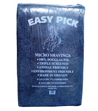 A blue plastic-wrapped bale of Easy Pick Douglas Fir micro shavings for animal bedding.