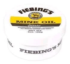 A white container of Fiebing's Mink Oil paste with a yellow and black label.