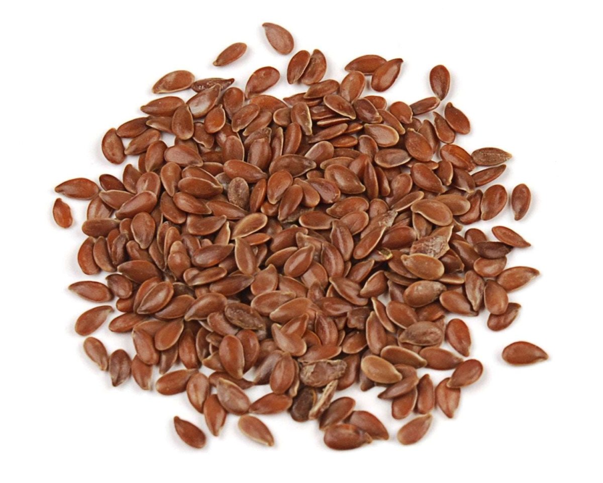 A pile of small, smooth, brown flax seeds scattered against a white background.