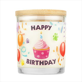 A nine-ounce Happy Birthday candle in a glass jar with a wooden lid, featuring a cupcake and balloon design.
