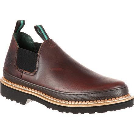 A brown leather slip-on work shoe with elastic side panels and a thick, lugged rubber outsole.