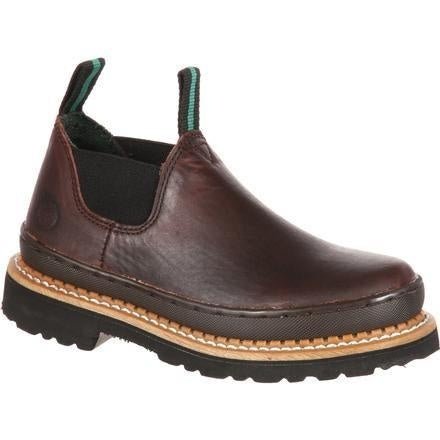 A brown leather slip-on shoe for children with elastic side panels and a thick rubber outsole.