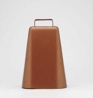 A copper-colored steel cowbell with a tall, narrow shape and a top handle.