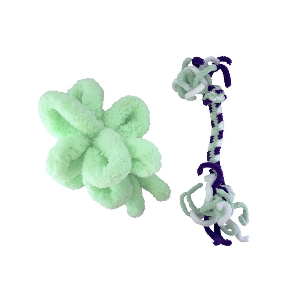 Two cat toys made of soft yarn, one a light green loop ball and the other a purple and white rope.
