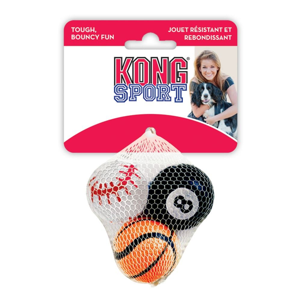 A mesh bag containing three Kong Sport dog balls designed like a baseball, an 8-ball, and a basketball.