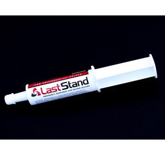 A white oral syringe of Last Stand digestive support paste for calves on a black background.