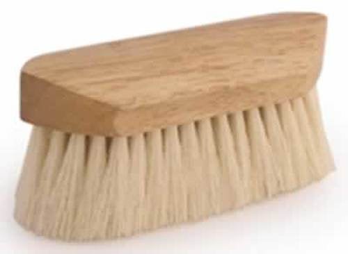 A small, rectangular wooden brush with soft, white tampico bristles.