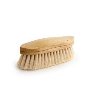 A curved wooden grooming brush with soft white tampico bristles.