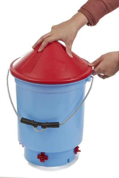 A person places a red lid on a blue Little Giant Deluxe Hen Hydrator bucket.