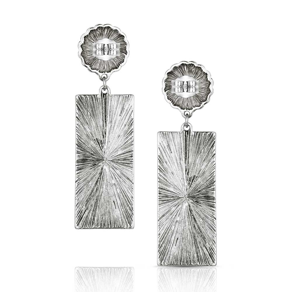 A pair of silver-tone earrings featuring a round concho stud attached to a rectangular drop.