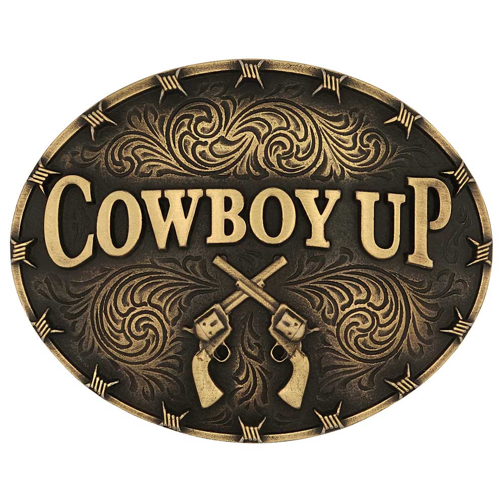An oval belt buckle featuring the words Cowboy Up and crossed revolvers with filigree detailing.