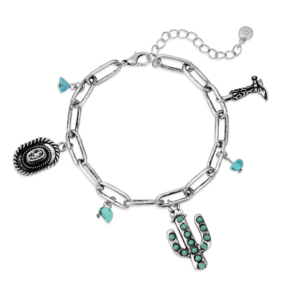 A silver chain charm bracelet featuring western-themed charms and turquoise accents.