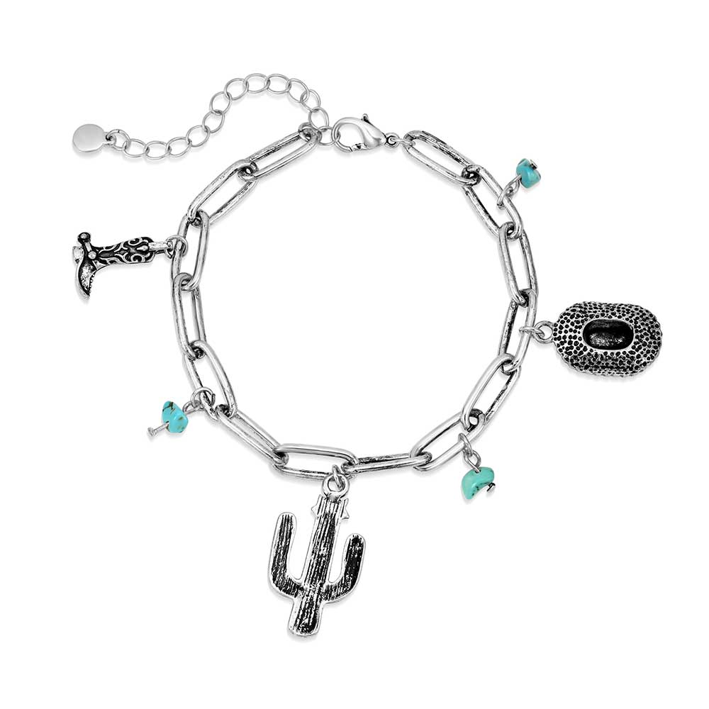 A silver chain charm bracelet featuring western-themed charms and turquoise stones.