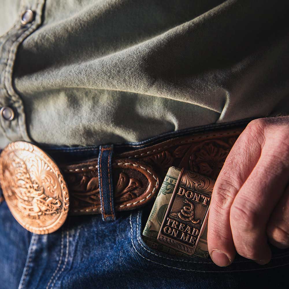 A vintage bronze money clip featuring a Gadsden snake and the phrase Don't Tread On Me.