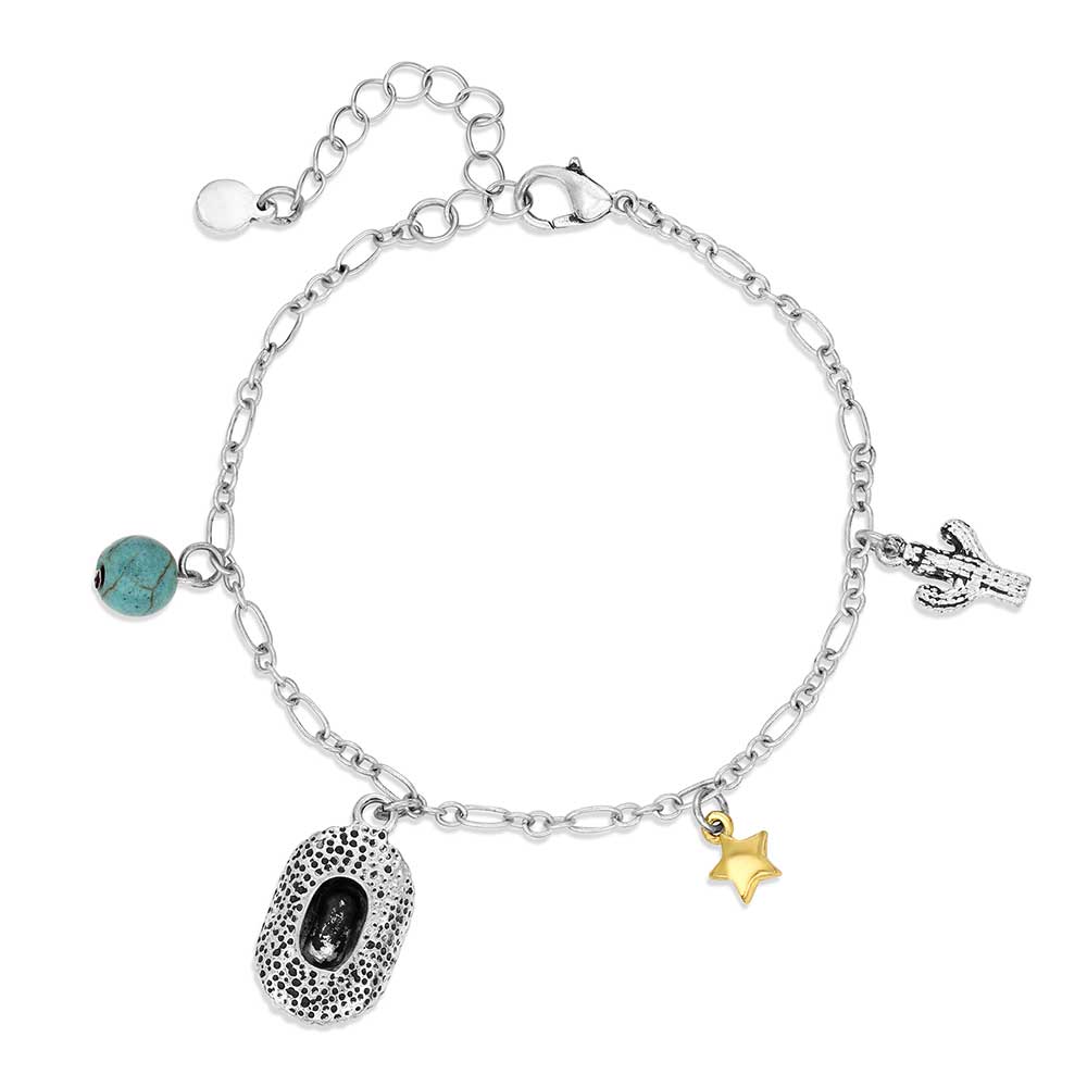 A silver chain charm bracelet featuring a turquoise bead, cowboy hat, gold star, and cactus charm.