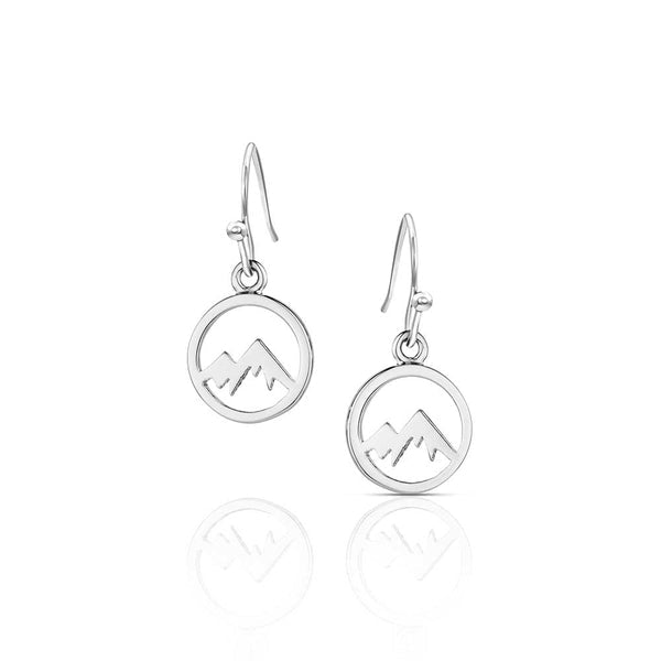 Silver drop earrings featuring a circular charm with a mountain peak cutout design.