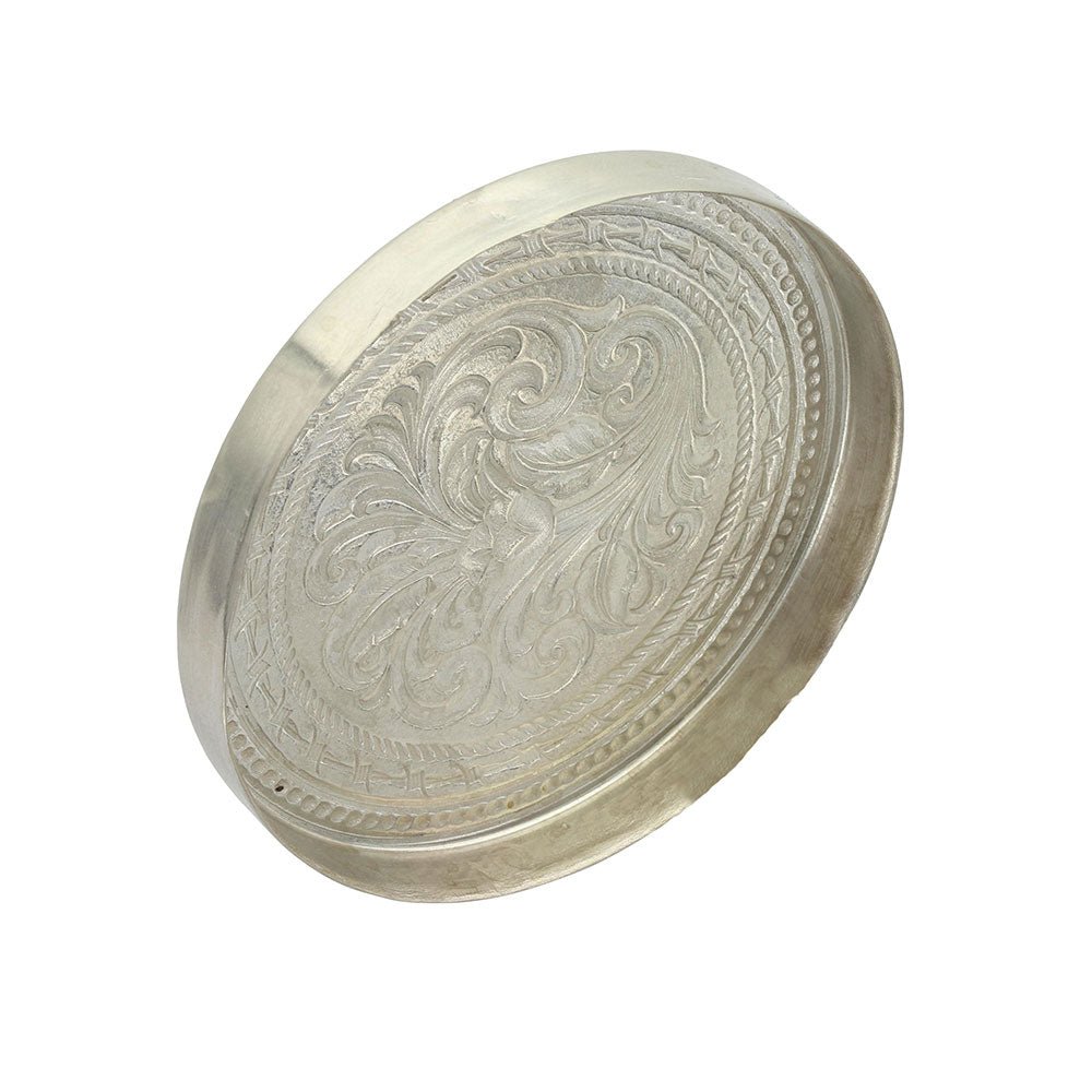 A round German silver snuff lid featuring intricate scrollwork and a beaded border.
