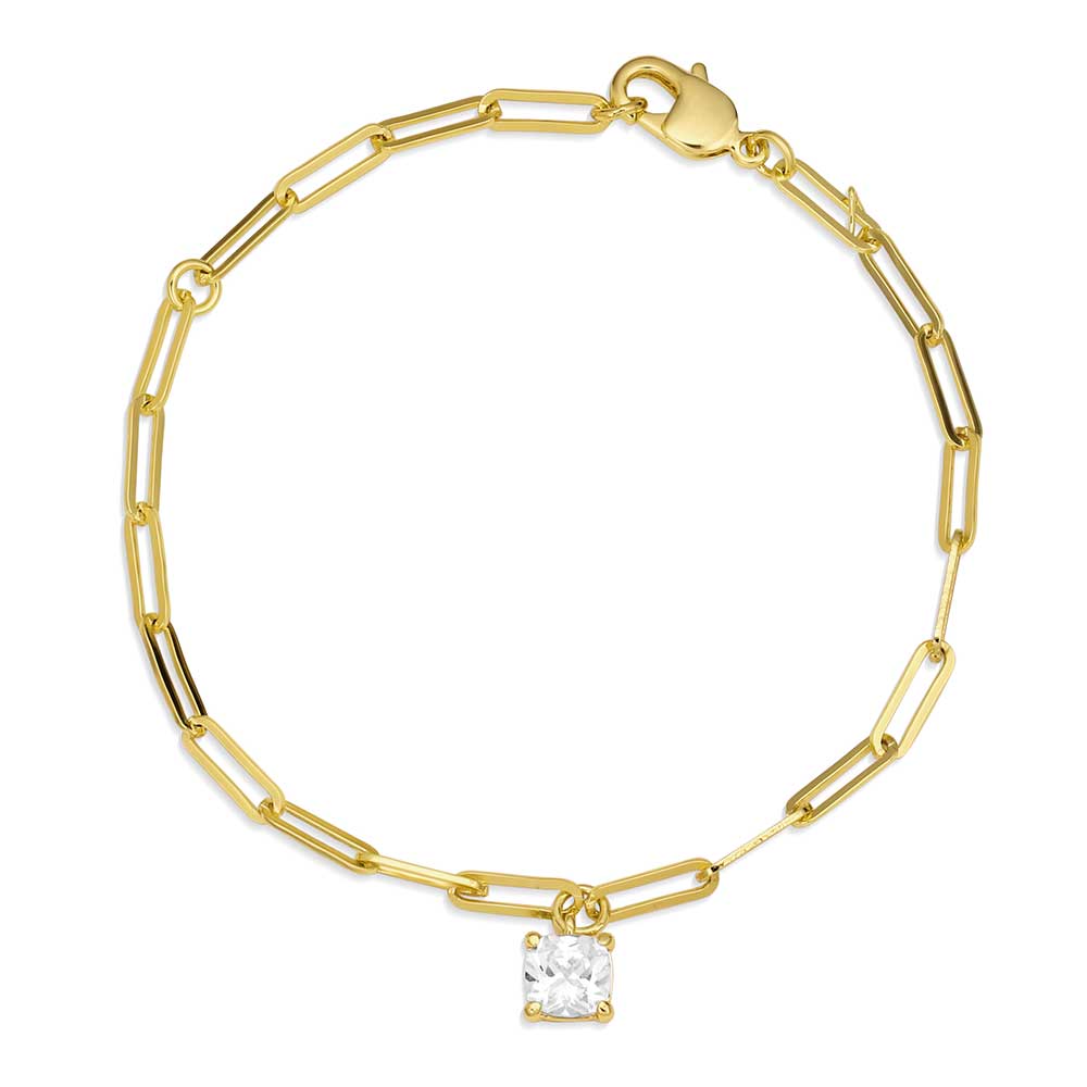 A gold paperclip chain bracelet featuring a single square solitaire stone charm.