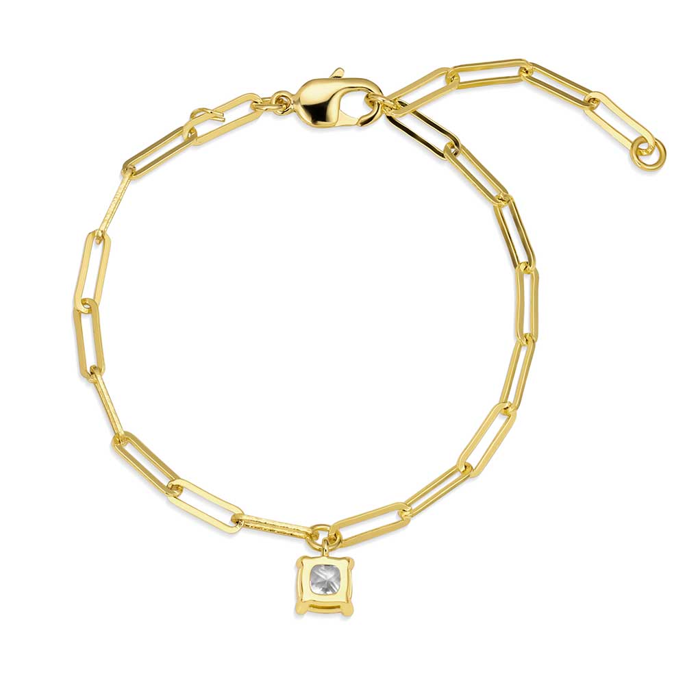 A gold paperclip chain bracelet featuring a single square solitaire stone charm.