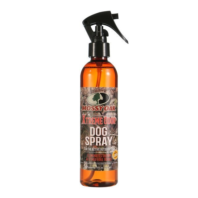 An eight-ounce bottle of Mossy Oak Xtreme Odor dog spray with a camouflage label and spray nozzle.