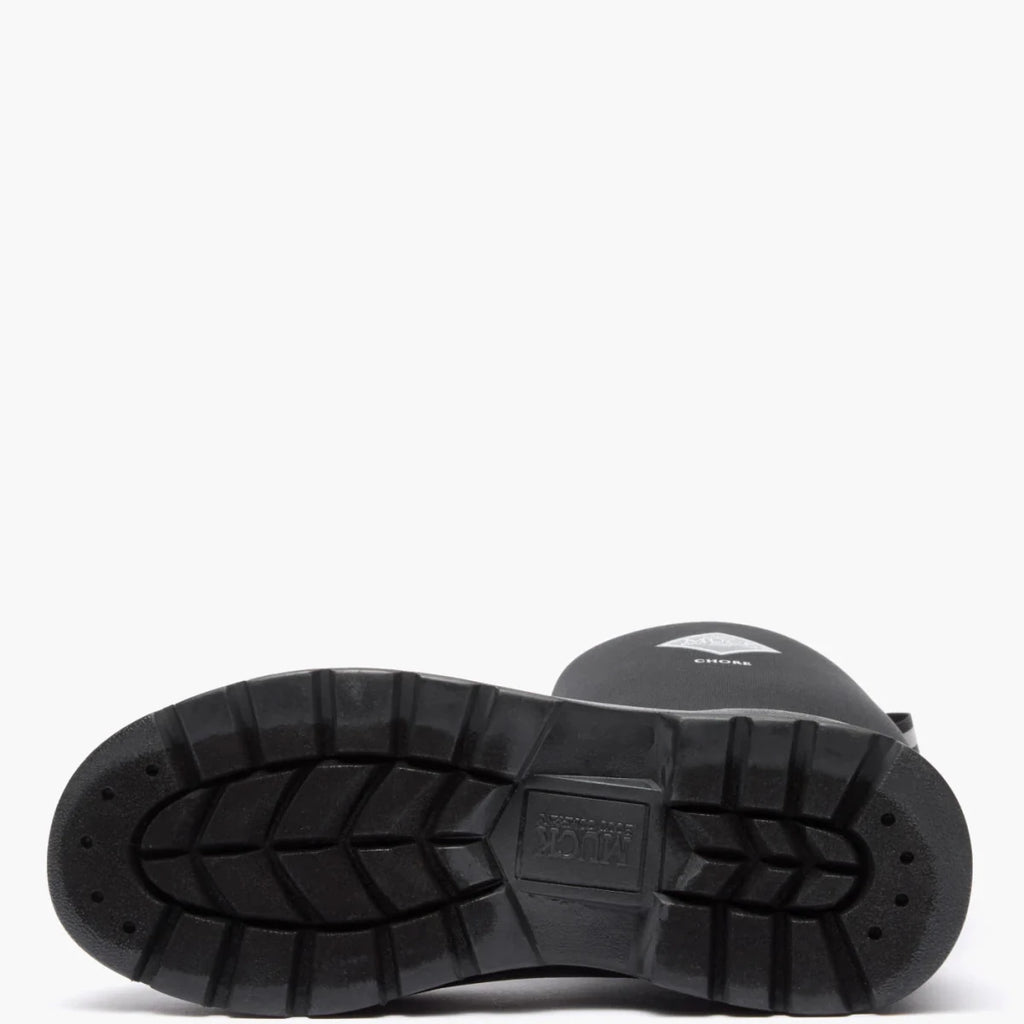 The black rubber sole of a Muck Chore boot features a rugged tread pattern and brand logo.