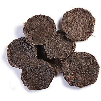 A cluster of round, dark brown beef lung dog treat patties on a white background.