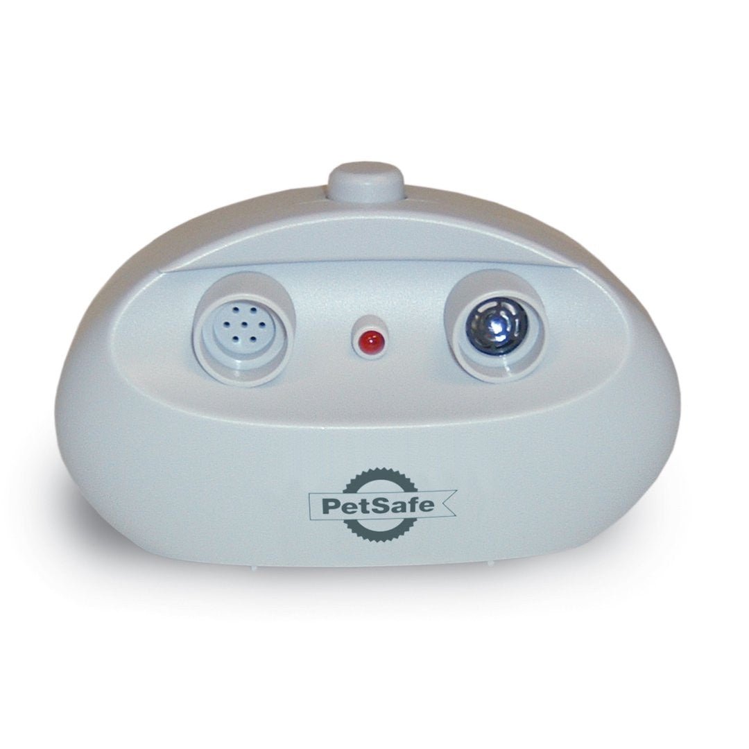 A grey PetSafe indoor bark control device with a microphone, indicator light, and speaker.