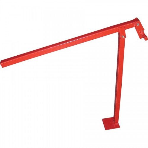 A red metal T-post puller tool with a long handle and a flat base for leverage.