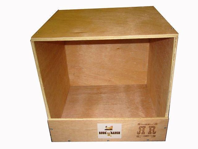 A single-hole wooden nesting box for chickens with a Rugg Egg Ranch logo on the front panel.