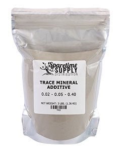 A clear plastic bag filled with grey powder labeled as Sparetime Trace Mineral Additive.