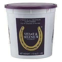 A white plastic tub of Vitamin E and Selenium horse supplement with a purple lid.
